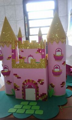 a pink castle made out of cardboard sitting on top of a table