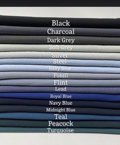 a stack of different colored shirts with the names of their colors on them in black, gray, blue, and white