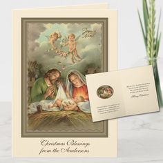 a christmas card with an image of the birth of jesus and two angels on it