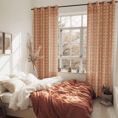 a bed sitting under a window in a bedroom