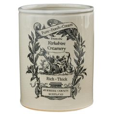 a white ceramic jar with black and white graphics