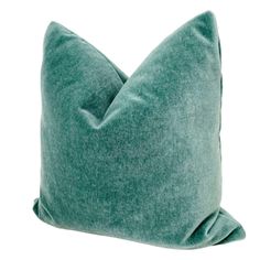 a green pillow on a white background