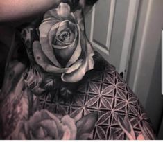 a woman's neck covered in tattoos and flowers