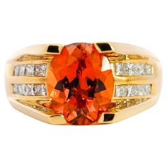 18K yellow gold oval cut Orange Spessartine Garnet and princess cut diamond ring. The Spessartine Garnet is mounted in a sharp, 4-prong setting that levitates the gem above the setting. Otherwise known as a floated set, for its optics as a gemstone floating in mid-air. The diamonds are eye clean and channel-tension set. Extremely white, and cut to perfection. Offering excellent contrast to the rich orange of the garnet and the bright yellow 18k gold setting. GIA Certification Description: Center stone set in a yellow metal ring with numerous near-colorless rectangular modified brilliants. Item Details: - Type: Unisex Cocktail Ring - Metal: 18K Yellow Gold - Weight: 13.57 Grams - Setting: Prong, Channel - Size: 8 (adjustable) __________________________________ Center Stone Details: - Type: Princess Cut Diamond Ring, Spessartine Garnet, Cut Orange, Garnet And Diamond Ring, Diamond Ring Princess Cut, Princess Cut Diamond, Domed Ring, Garnet Rings, Princess Cut Diamonds