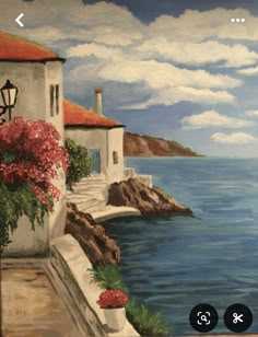 a painting of a house by the ocean with red flowers on it's balcony