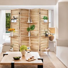 a living room filled with lots of furniture next to a large wooden wall mounted clock