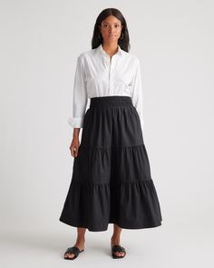 Go with the flow in our 100% Organic Cotton Tiered Maxi Skirt. Crafted with care from crisp organic cotton poplin, this effortless skirt is a perfect blend of softness and structure. With a timeless tiered silhouette, a comfy wide elastic waistband, and, yes, pockets, we covered all the details to create a go-to style you're sure to love.  | Quince | Women's Tiered Maxi Skirt in Black, Size Small, Organic Cotton Tiered Maxi Skirt Outfit, Black Tiered Maxi Skirt, Modest Feminine Outfits, 2024 Style, Maxi Skirt Outfits, Black Maxi Skirt, Tiered Maxi Skirt, Go With The Flow, Scoop Neck Tee