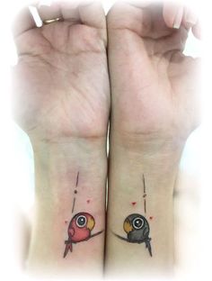 two small tattoos on both wrist and arm, one with an owl and the other with a bird