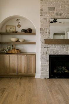 a living room filled with furniture and a fire place in front of a brick fireplace