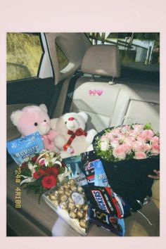 flowers, teddy bears and chocolates in the back seat of a car for valentine's day