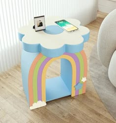 a table with a phone on top of it in the shape of a rainbow arch