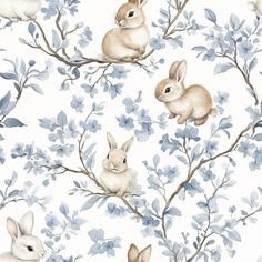 a watercolor painting of rabbits sitting in a tree with blue flowers and leaves on it