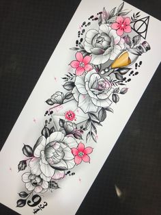 an arm tattoo with flowers on it