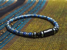 🎁 Embrace sophistication with this exquisite Blue Lapis Lazuli men's bracelet featuring handcrafted Black Tourmaline and Hematite jewelry in a minimalist style, making it an ideal birthday gift idea. This elegant piece combines style and craftsmanship to create a unique accessory that adds a touch of charm to any ensemble. Material details: -8mm Black Tourmaline -4mm Lapis Lazuli -4mm Hematite PACKAGING * Each piece of our bracelet is packaged in a black gift box with ribbon, perfect for gift-g Handmade Hematite Bracelets As Gift, Magnetic Hematite Beaded Bracelets Gift, Blue Hematite Jewelry For Gift, Blue Hematite Jewelry As A Gift, Adjustable Magnetic Jewelry With Round Beads, Spiritual Hematite Bracelet Jewelry, Magnetic Adjustable Beaded Bracelets As Gift, Adjustable Magnetic Beaded Bracelets As Gift, Spiritual Hematite Jewelry For Gifts