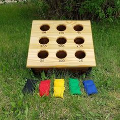 a wooden board game set sitting in the grass