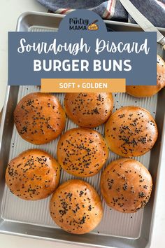 some buns are sitting on a pan with sprinkled black sesame seeds in them