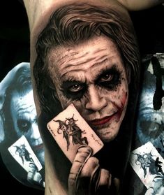 the joker is holding a card in his right hand, while he's wearing makeup