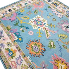 a blue rug with colorful floral designs on it