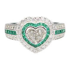 Brilliant Art Deco Style Ring Very special & unique, 18k White Gold 8.30 grams. Total all Diamonds 1.18 carat ( center stone is heart shape cut Diamond 0.44 carat IJ-I1 ) Emeralds total 0.71 carat. overall design area size on the top is, 13 mm. Finger size 7. all the small diamonds are HI-SI all stones are fully natural and none treated ! R2422H60x53 Luxury Heart Cut Emerald Promise Ring, Luxury Green Heart Cut Rings, Gia Certified Heart Cut Diamond Ring, Heart-shaped Gia Certified Ring For Anniversary, Gia Certified Heart-shaped Ring For Anniversary, Gia Certified Heart Shaped Anniversary Ring, Gia Certified Heart Shaped Fine Jewelry Ring, Gia Certified Heart Diamond Rings, Fine Jewelry Gia Certified Heart-shaped