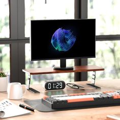 a desktop computer monitor sitting on top of a wooden desk