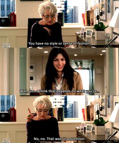 an older woman sitting at a desk talking on the phone with another woman standing next to her