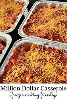 four trays filled with food covered in cheese and chili sauce on top of each other