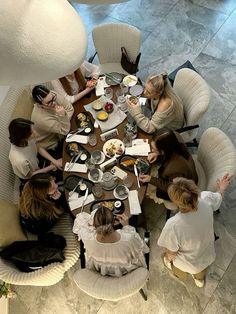 a group of people sitting around a table eating food