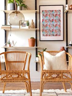 two wicker chairs sitting next to each other on top of a rug