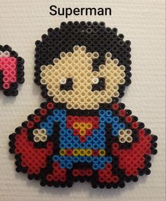 an image of a beaded brooch with the name superman on it