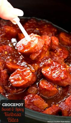 the slow cooker is filled with sweet and spicy kielbasa bites