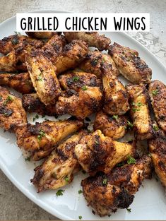 grilled chicken wings on a white plate with the words grilled chicken wings above it