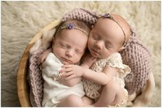 two newborn babies are cuddling in a basket