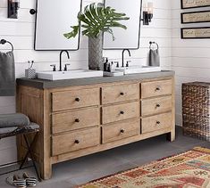 a bathroom with two sinks and mirrors on the wall next to a rug in front of it