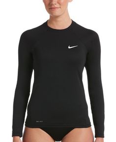 a woman wearing a black top with white nike logo on the chest and long sleeves