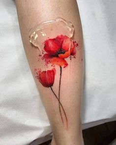 a woman's leg with red flowers painted on it