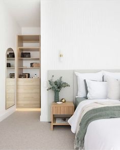 a bedroom with white walls and beige carpet