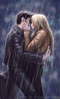 a man and woman kissing in the rain