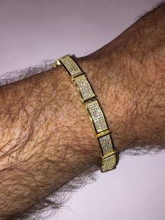 "This listing is for a stunning iced out solid 925 Sterling silver bracelet that comes in 2 finishes: rhodium (white) or 14k yellow gold finish. Bracelet is adorned with 12 carats of man-made diamond, making it super icy! Weight is approximately 29 grams and thickness is 11mm wide. 8.5\" length FREE SHIPPING IN THE US!!" Gold Iced Out Tennis Bracelet For Anniversary, Gold Iced Out Cubic Zirconia Diamond Bracelet, Gold Iced Out Round Tennis Bracelet, Gold Iced Out Tennis Bracelet, Gold Iced Out Diamond Bracelet, Luxury Iced Out Gold Diamond Bracelet, Luxury Iced-out Diamond Bracelet For Gift, Luxury Men's Yellow Gold Diamond Bracelet, Luxury Iced-out Cuban Link Bracelet Gift