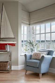 a blue chair sitting in front of a window