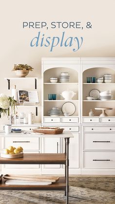 a kitchen with white cabinets and blue lettering on the wall that says prep store & display