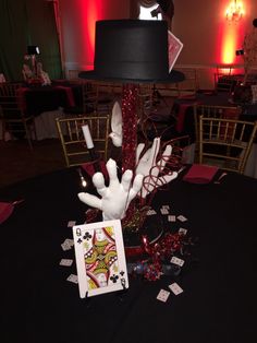 the table is set up for a casino themed party with cards and candles on it