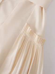 This Pintuck Pocket Skirt in Ivory is the perfect addition to any wardrobe. The unique pintuck detailing adds texture and sophistication to the classic A-line silhouette. Chic Pleated Flared Skirt With Ruffles, Chic Ruffled Pleated Flared Skirt, Chic Pleated Ruffled Flowy Skirt, Elegant Solid Color Tiered Skirt, Elegant Solid Tiered Skirt, Chic Spring Pleated Skirt With Ruffles, Chic Pleated Ruffle Skirt For Spring, Chic Ruffled Pleated Skirt For Spring, Elegant Solid Color Tiered Skirt Dress