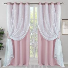 pink and white curtains hanging on a window