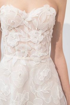 the back of a woman's dress with flowers on it