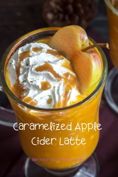 caramelized apple cider latte in a glass with whipped cream on top