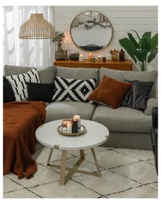 a living room filled with furniture and candles