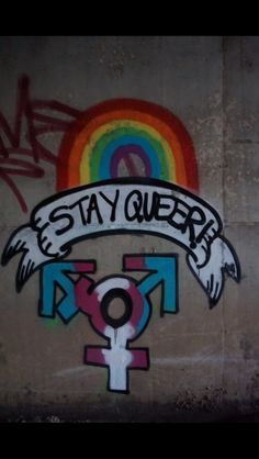 graffiti on the side of a building that says stay queen with an angel and rainbow above it