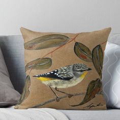 a bird sitting on top of a tree branch with leaves and berries around it throw pillow