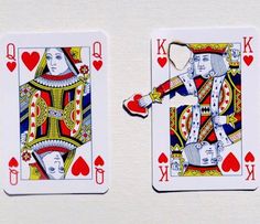 two playing cards with one king and the other queen