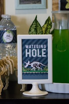 there is a sign that says watering hole on the table